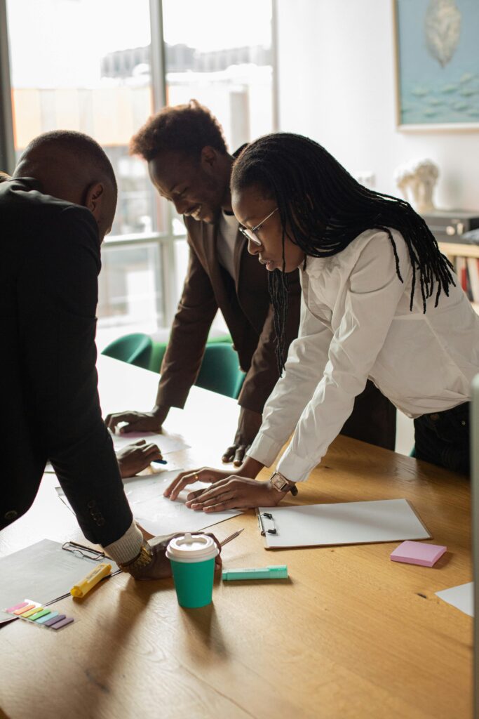 A diverse group of professionals engaged in a collaborative meeting in a contemporary office setting.